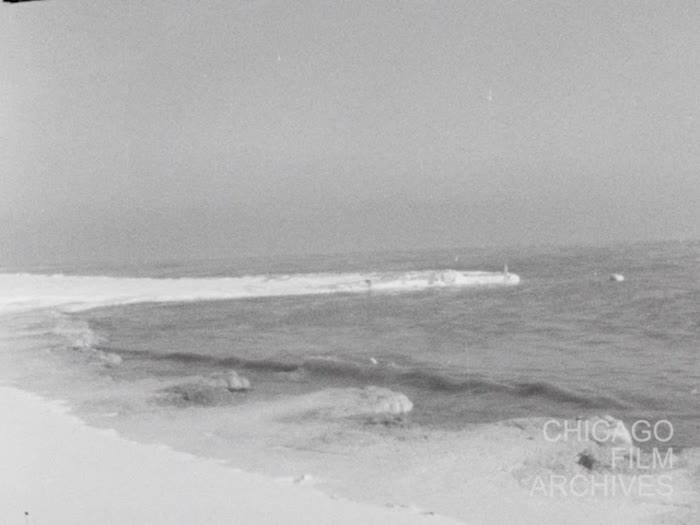 Chicago---Lake scenes of snow &amp; waves, skyline, Christmas shoppers, policemen directing traffic, etc. Sil. uncut neg. 12-21-60
